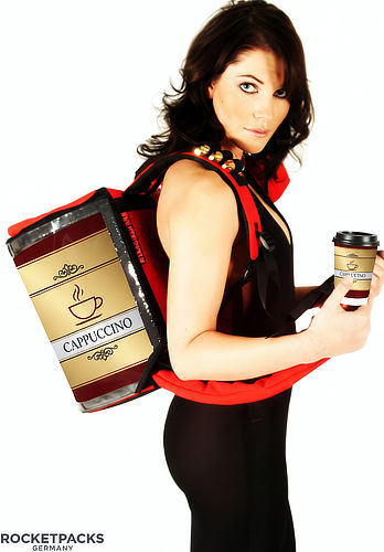 Mobile coffee backpack dispenser equipped with an integrated cup holder for efficient street vending.
