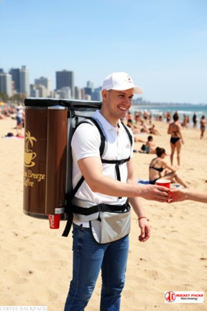Mobile Coffee Dispenser Backpack with flavored latte in Warsaw cinema marketing event, designed for outdoor event service, customer sampling, and beverage promotional activities.