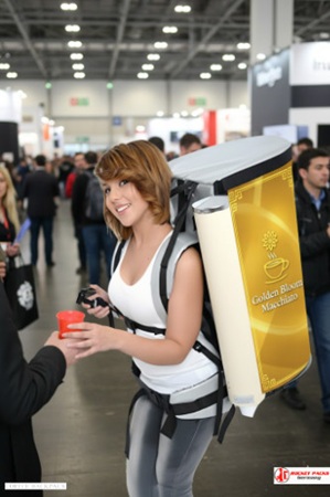 Professional Coffee Dispenser Backpack serving Caffe Latte in Paris open air shopping area, designed for POS display and product sales promotion with branded event presence.